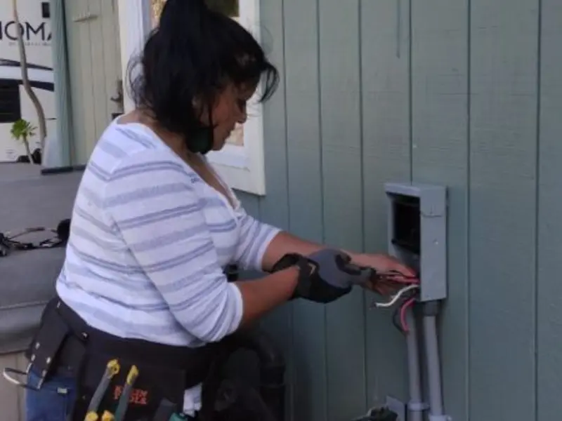 Licensed electrician wiring an exterior subpanel in Dover