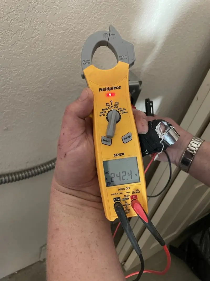 Voltage testing with clamp meter during Recessed Lighting Installation in Dover